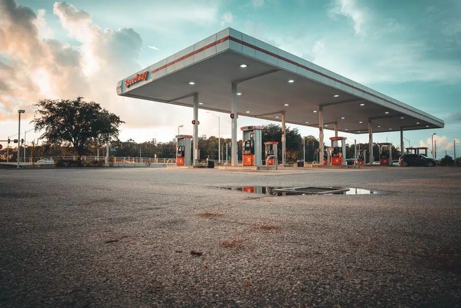 Explore a modern gas station with a scenic sky at dusk, highlighting its architectural design and peaceful ambiance.